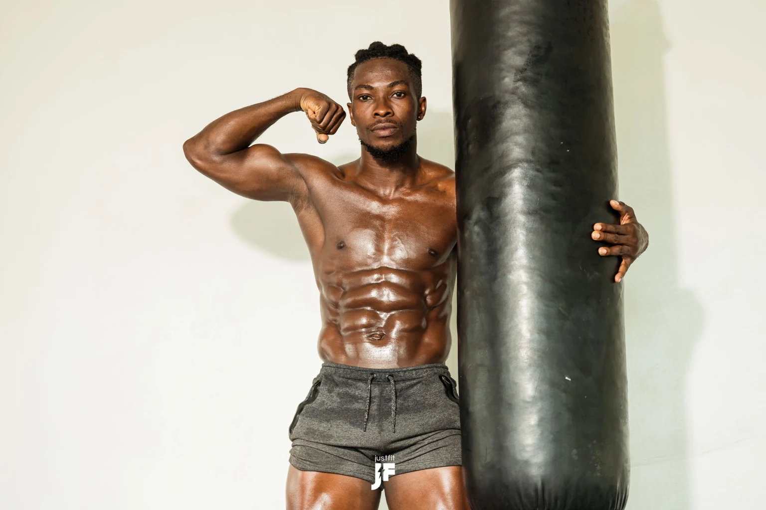 Lymon beside a punching bag, showing his upper body and training space